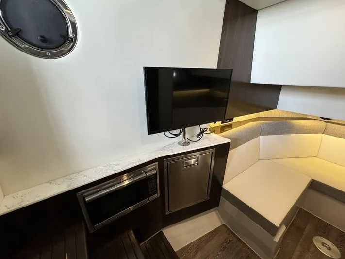  Yacht Photos Pics 2021 Cruisers Yachts 38 GLS I/O interior with TV, seating, and kitchenette.