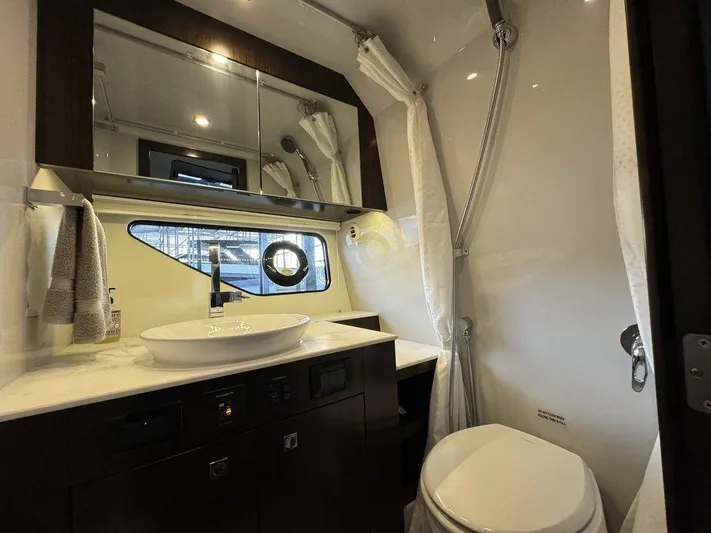  Yacht Photos Pics Luxurious bathroom in 2021 Cruisers Yachts 38 GLS I/O with modern fixtures and elegant design.