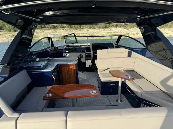  Yacht Photos Pics 2021 Cruisers Yachts 38 GLS I/O interior with seating and tables on a sunny day.