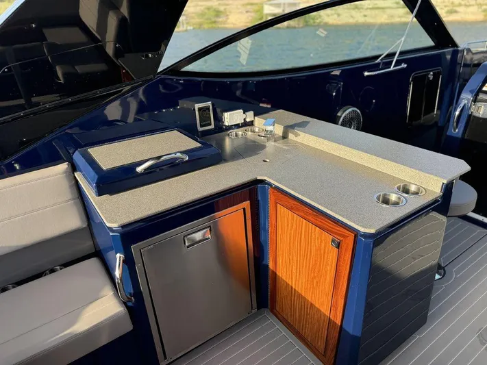  Yacht Photos Pics 2021 Cruisers Yachts 38 GLS I/O interior with kitchenette, featuring sink, storage, and seating.