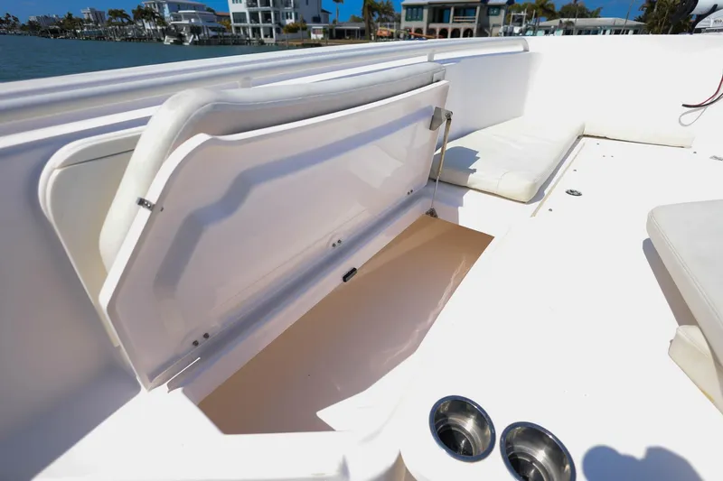  Yacht Photos Pics 2015 Everglades 355 Center Console boat with open storage compartment and cup holders.