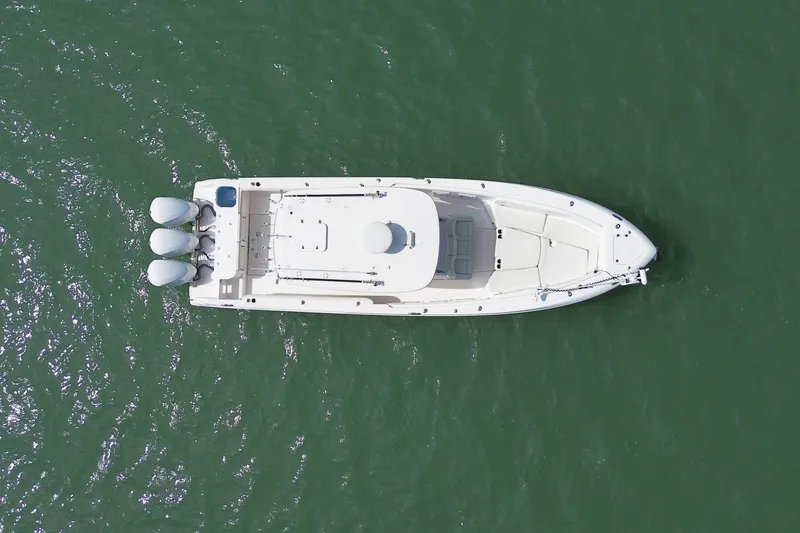  Yacht Photos Pics Overhead view of 2015 Everglades 355 Center Console boat on green water.