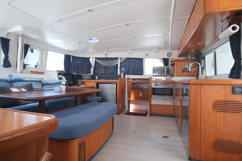 Sv Hypnautic Yacht Photos Pics Interior of 2002 Lagoon 440 catamaran with modern kitchen and seating area.
