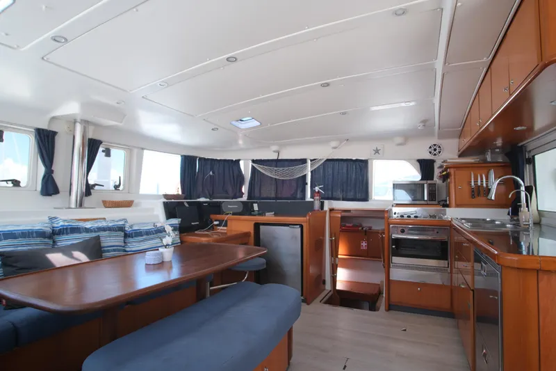 Sv Hypnautic Yacht Photos Pics Spacious interior of 2002 Lagoon 440 catamaran with dining area and kitchen.