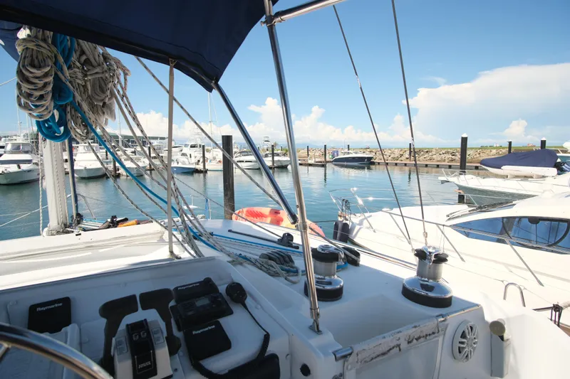 Sv Hypnautic Yacht Photos Pics Lagoon 440 catamaran cockpit view in marina, showcasing sailing equipment and clear blue sky.