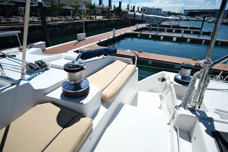 Sv Hypnautic Yacht Photos Pics Lagoon 440 catamaran, 2002 model, docked at marina with clear blue water.