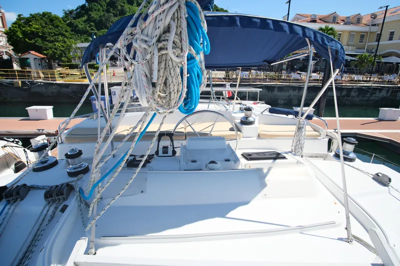 Sv Hypnautic Yacht Photos Pics Lagoon 440 catamaran, 2002 model, docked with ropes and canopy, sunny marina setting.