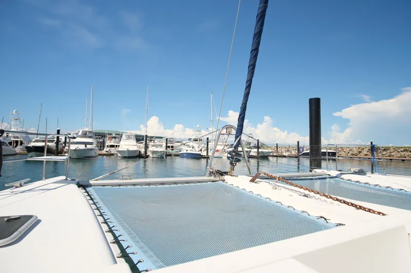 Sv Hypnautic Yacht Photos Pics 2002 Lagoon 440 catamaran docked at a marina under clear blue skies.