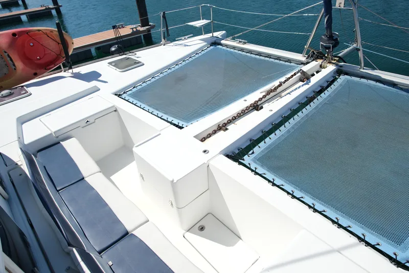Sv Hypnautic Yacht Photos Pics Lagoon 440 catamaran deck with seating and netting, 2002 model, docked at marina.