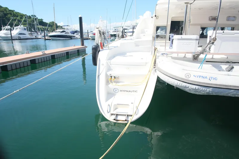 Sv Hypnautic Yacht Photos Pics 2002 Lagoon 440 catamaran docked at marina, calm water, sunny day.