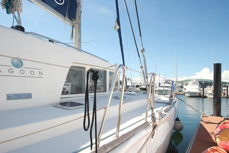 Sv Hypnautic Yacht Photos Pics 2002 Lagoon 440 catamaran docked at marina under clear blue sky.