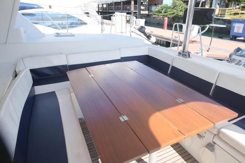 Sv Hypnautic Yacht Photos Pics Spacious outdoor seating area on a 2002 Lagoon 440 yacht with wooden table.