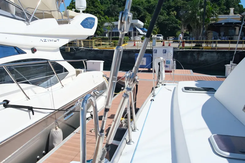 Sv Hypnautic Yacht Photos Pics Docked Lagoon 440 catamaran from 2002 alongside other boats at a marina.