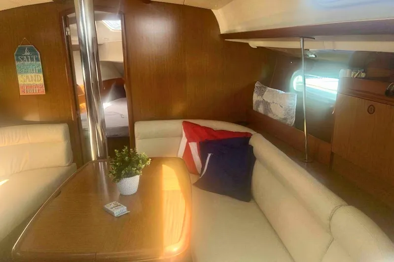 Phantom Yacht Photos Pics Cozy interior of 2007 Jeanneau Sun Odyssey 39i sailboat with seating and decor.