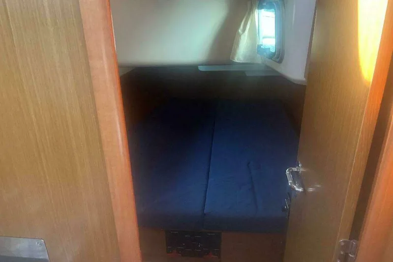 Phantom Yacht Photos Pics Cabin interior of 2007 Jeanneau Sun Odyssey 39i sailboat with blue bedding.