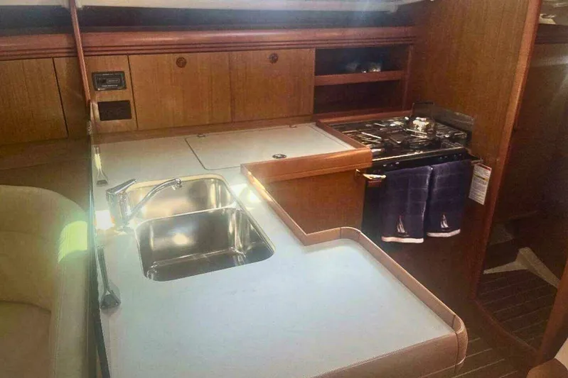 Phantom Yacht Photos Pics 2007 Jeanneau Sun Odyssey 39i yacht interior kitchen with sink and stove.