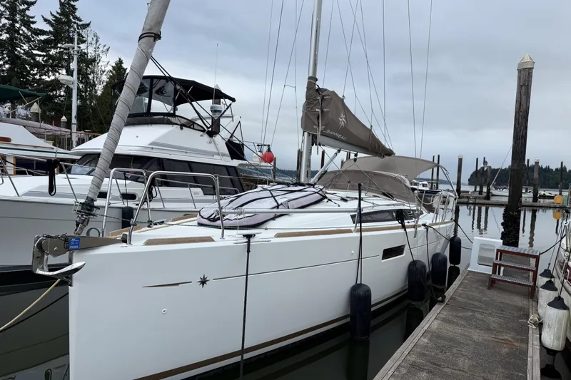 A Bientot Yacht Photos Pics 2016 Jeanneau Sun Odyssey 349 sailboat docked at marina, overcast sky.