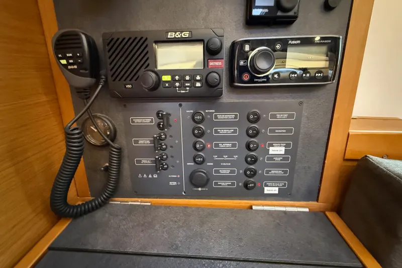 A Bientot Yacht Photos Pics Control panel of a 2016 Jeanneau Sun Odyssey 349 sailboat, featuring communication and navigation equipment.