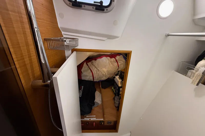 A Bientot Yacht Photos Pics Interior storage of 2016 Jeanneau Sun Odyssey 349 sailboat, featuring organized compartments.