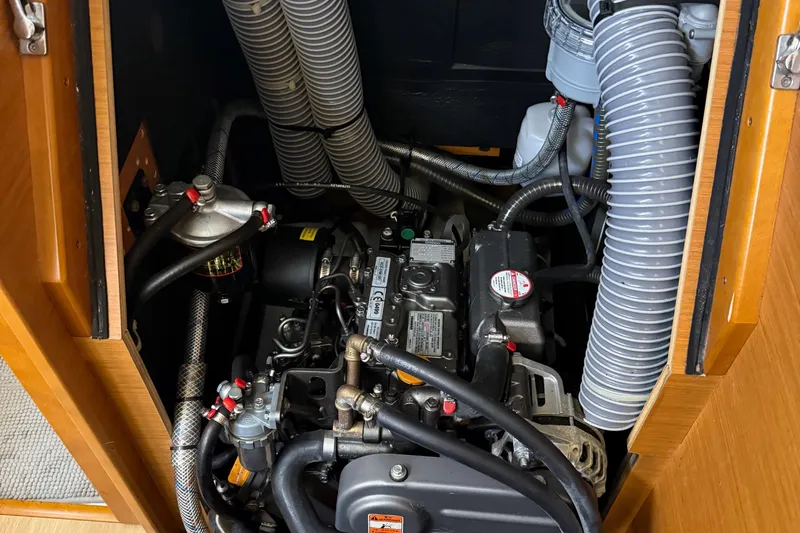 A Bientot Yacht Photos Pics Engine compartment of a 2016 Jeanneau Sun Odyssey 349 sailboat, showcasing detailed components.