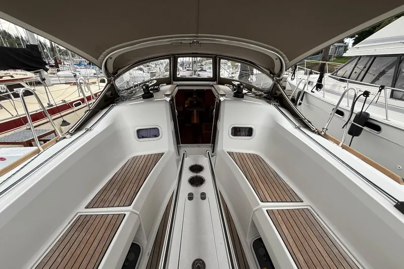 A Bientot Yacht Photos Pics Cockpit of 2016 Jeanneau Sun Odyssey 349 sailboat with teak seating and canopy.