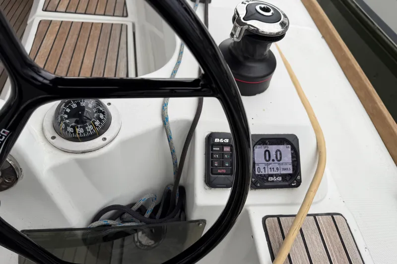 A Bientot Yacht Photos Pics Cockpit of 2016 Jeanneau Sun Odyssey 349 with navigation instruments and compass.