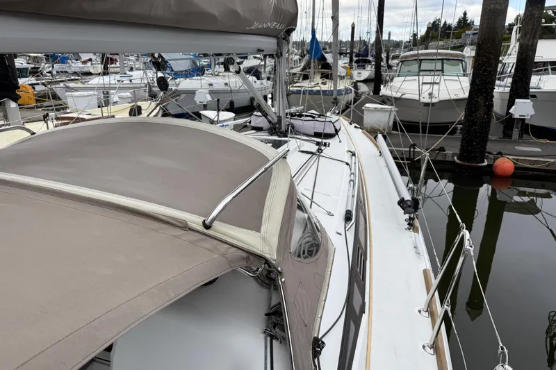A Bientot Yacht Photos Pics 2016 Jeanneau Sun Odyssey 349 sailboat docked in a marina, surrounded by other boats.