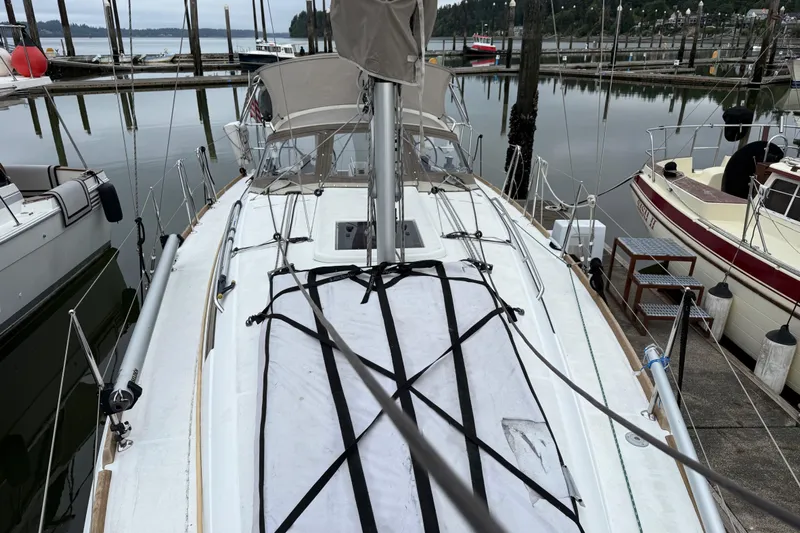 A Bientot Yacht Photos Pics 2016 Jeanneau Sun Odyssey 349 sailboat docked at a marina, view from the deck.