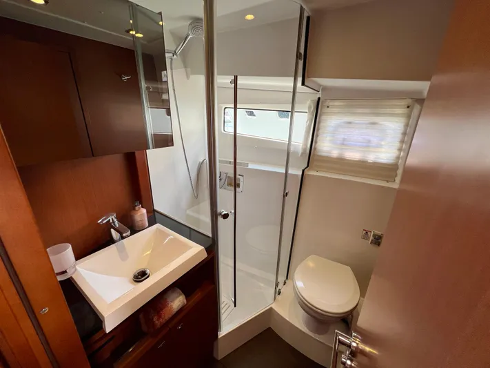  Yacht Photos Pics Luxurious bathroom in 2017 Jeanneau Velasco 43 yacht with modern fixtures and glass shower.