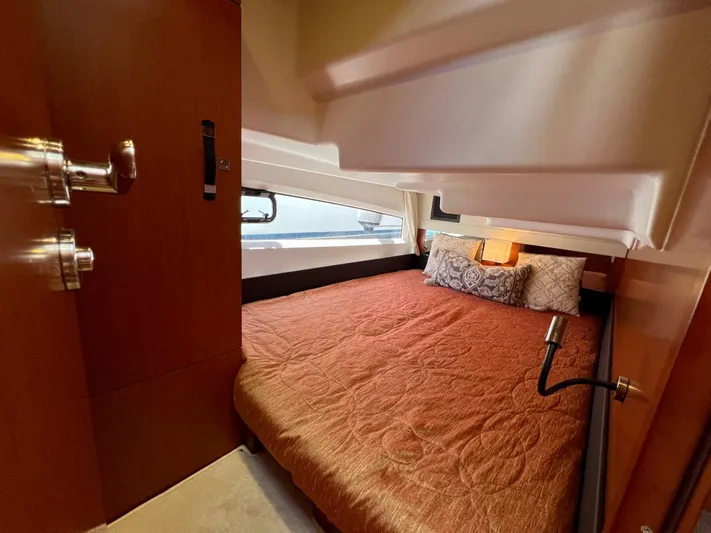  Yacht Photos Pics Cozy cabin interior of 2017 Jeanneau Velasco 43 with a comfortable bed and elegant decor.