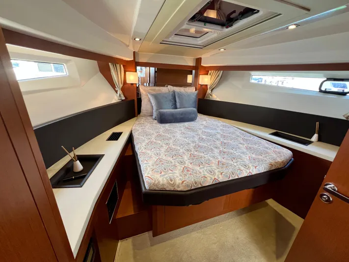  Yacht Photos Pics Luxurious cabin interior of 2017 Jeanneau Velasco 43 yacht with elegant bedding and modern design.