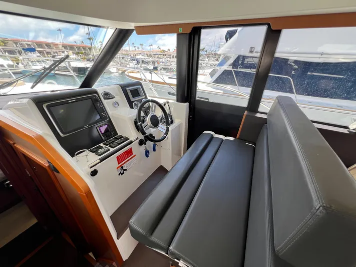  Yacht Photos Pics Helm station of 2017 Jeanneau Velasco 43 with modern controls and seating.