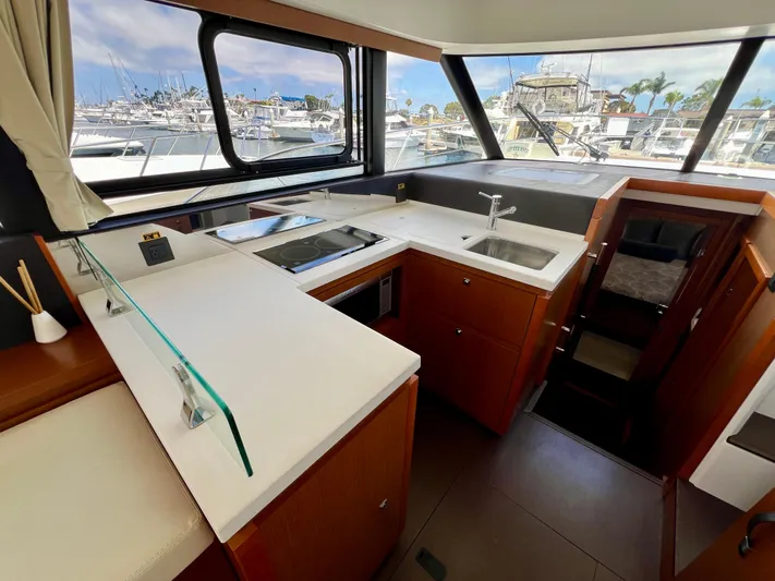  Yacht Photos Pics Modern kitchen interior of 2017 Jeanneau Velasco 43 yacht with marina view.