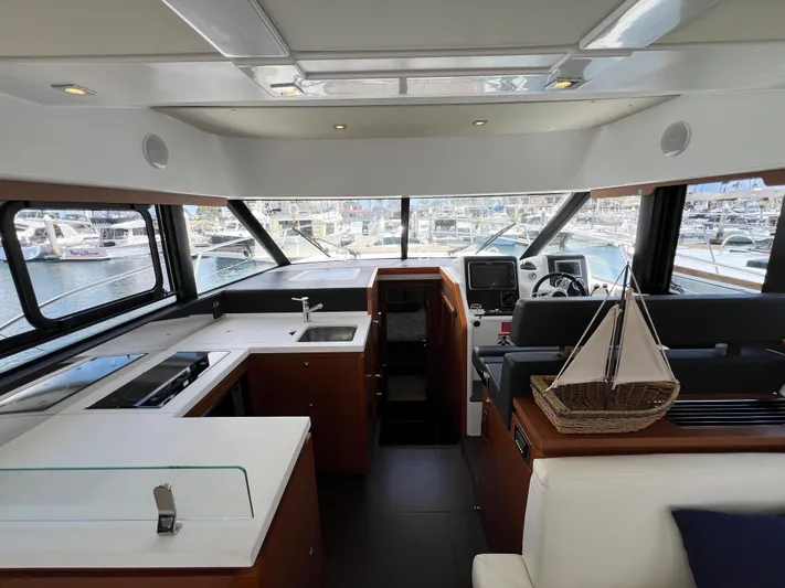  Yacht Photos Pics Interior of 2017 Jeanneau Velasco 43 yacht with modern kitchen and helm station.