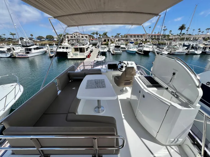  Yacht Photos Pics Flybridge view of 2017 Jeanneau Velasco 43 yacht docked in a marina.
