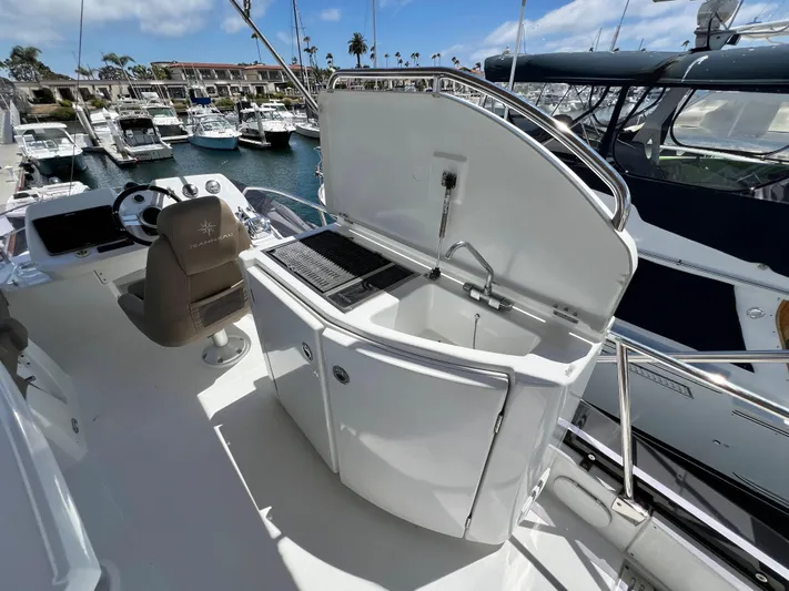  Yacht Photos Pics 2017 Jeanneau Velasco 43 yacht deck with helm, sink, and grill station.