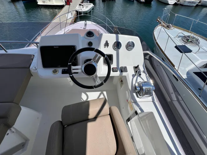  Yacht Photos Pics Helm of 2017 Jeanneau Velasco 43 yacht with steering wheel and controls.