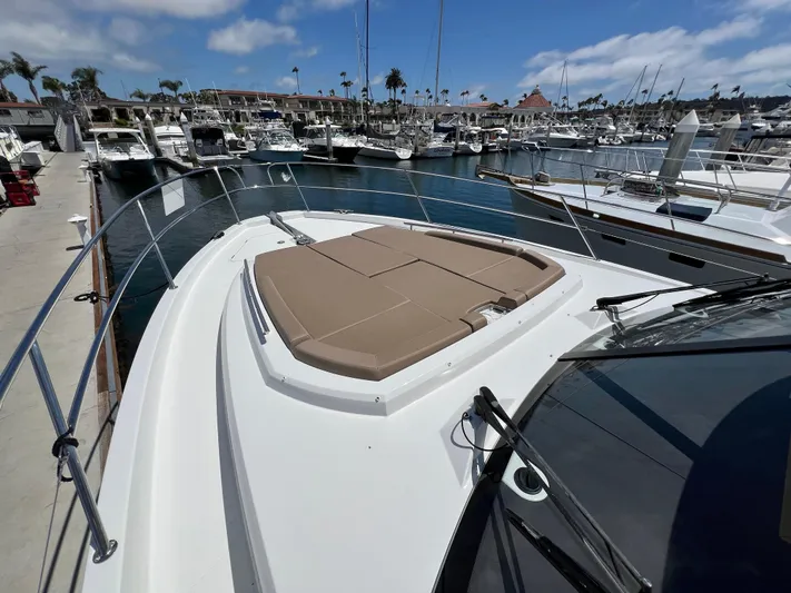  Yacht Photos Pics 2017 Jeanneau Velasco 43 yacht docked at marina, featuring spacious sunbathing area.