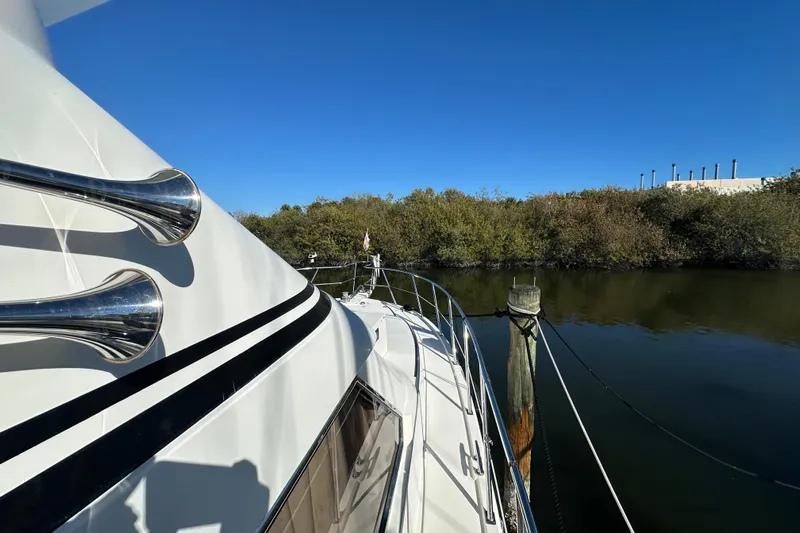  Yacht Photos Pics Novatec Islander 55 yacht, 2006 model, docked by a serene waterway.