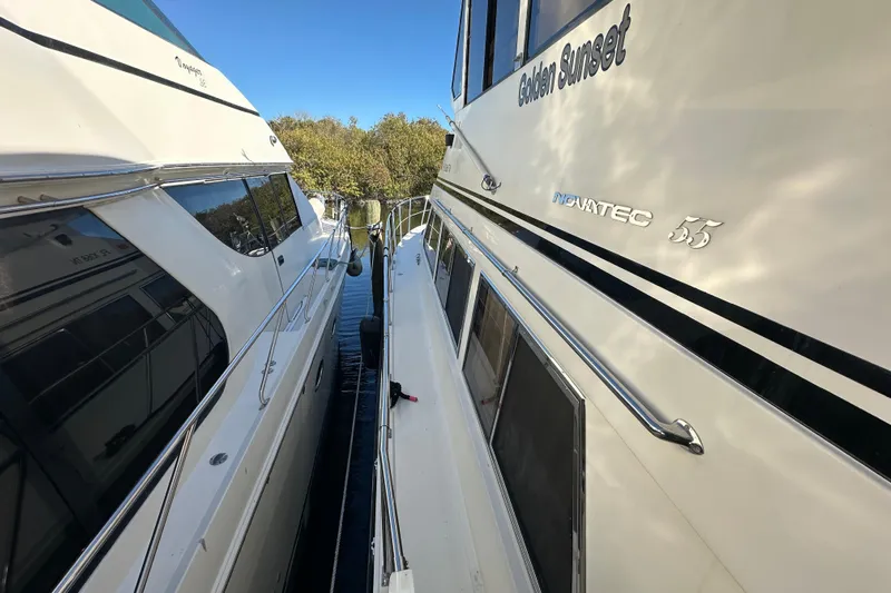  Yacht Photos Pics Novatec Islander 55 yacht, 2006 model, docked beside another vessel.