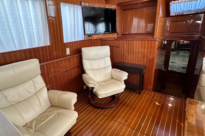  Yacht Photos Pics Luxurious interior of 2006 Novatec Islander 55 yacht with leather chairs and wood paneling.