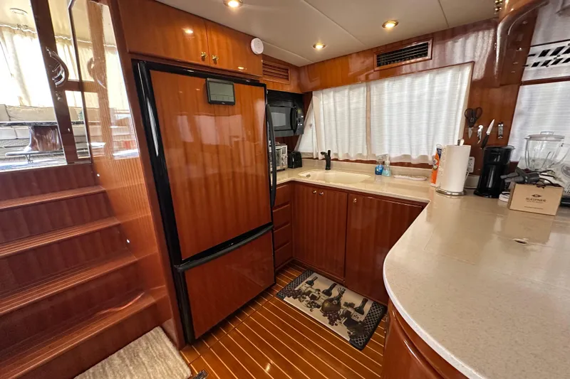  Yacht Photos Pics Luxurious kitchen interior of 2006 Novatec Islander 55 yacht with wood cabinetry and modern appliances.