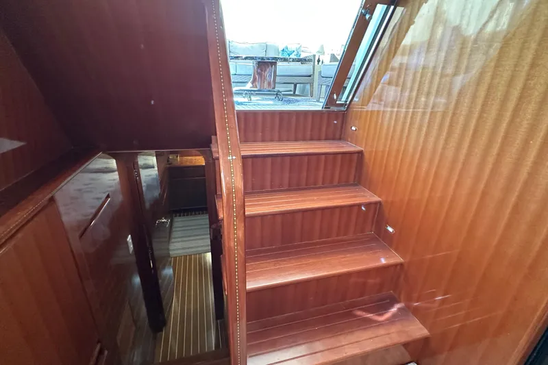  Yacht Photos Pics Interior stairs of 2006 Novatec Islander 55 yacht with polished wood finish.
