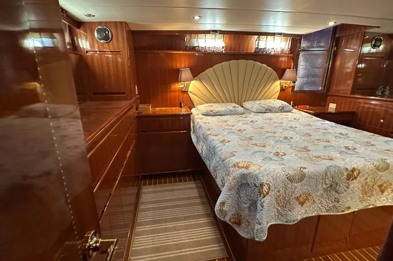  Yacht Photos Pics Luxurious bedroom in 2006 Novatec Islander 55 yacht with elegant wood paneling.