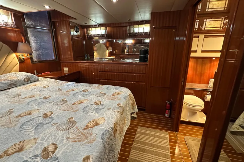  Yacht Photos Pics Luxurious 2006 Novatec Islander 55 yacht bedroom with elegant wood finish and ensuite bathroom.