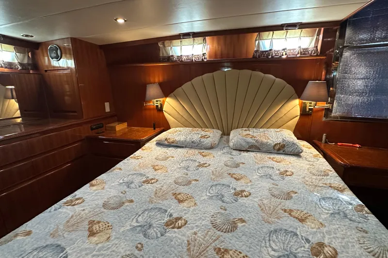  Yacht Photos Pics Luxurious bedroom interior of 2006 Novatec Islander 55 yacht with elegant bedding and wood paneling.