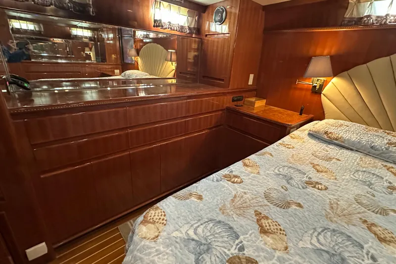  Yacht Photos Pics Luxurious 2006 Novatec Islander 55 yacht bedroom with elegant wood cabinetry and seashell-themed bedding.