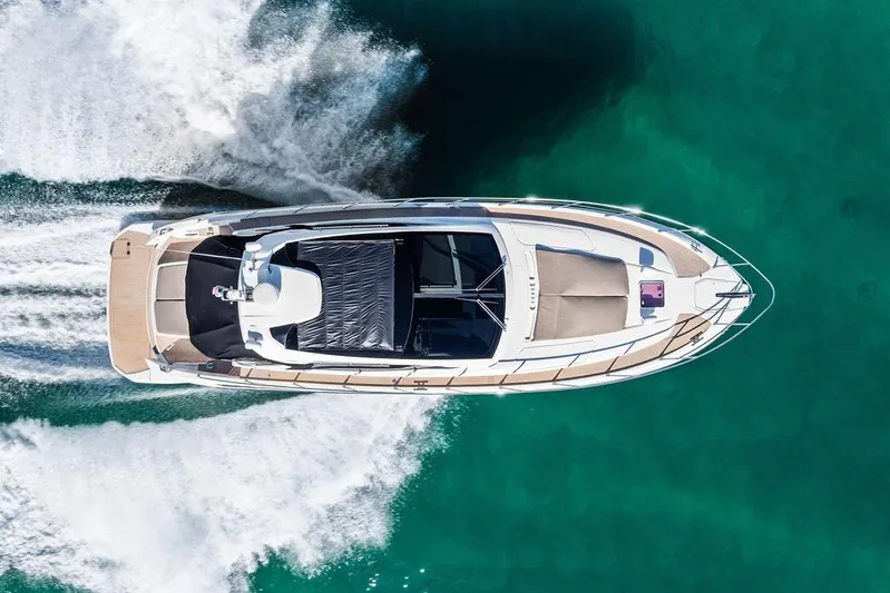  Yacht Photos Pics Aerial view of 2013 Azimut Atlantis 48 yacht cruising on turquoise water.