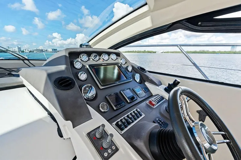  Yacht Photos Pics Helm of 2013 Azimut Atlantis 48 yacht with navigational controls and steering wheel.