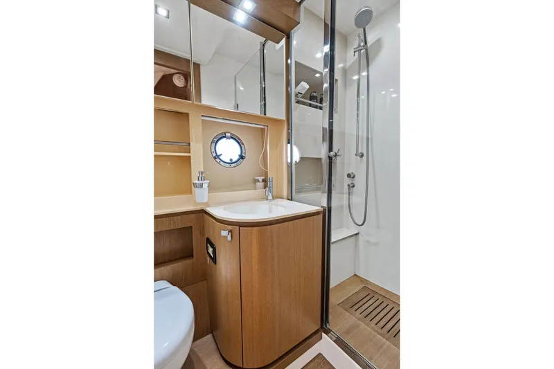  Yacht Photos Pics Luxurious bathroom in 2013 Azimut Atlantis 48 yacht with modern shower and wooden cabinetry.